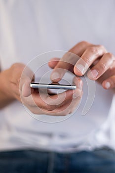 Young man using a touchscreen smartphone cell phone