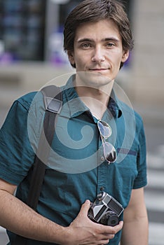 Young man using vintage film camera