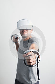 Young man using VR headset. Guy playing with VR glasses