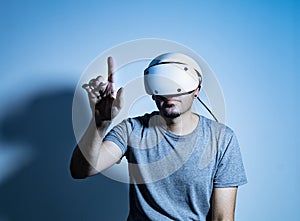 Young man using VR headset. Guy playing with VR glasses