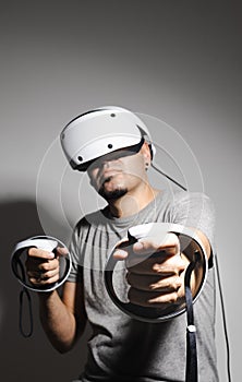 Young man using VR headset. Guy playing with VR glasses