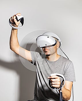 Young man using VR headset. Guy playing with VR glasses