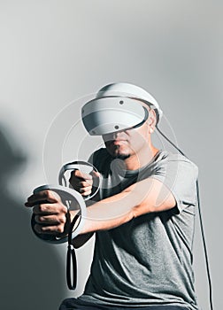 Young man using VR headset. Guy playing with VR glasses