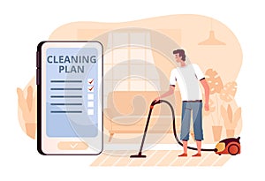 A young man vacuums a carpet at home in the living room. The concept of a mobile application for cleaning planning