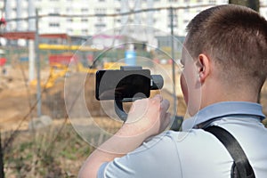 A young man videotaping on a smartphone.