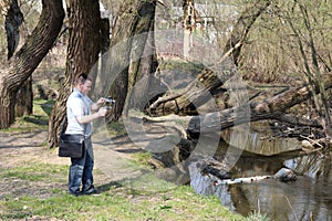 A young man videotaping on a smartphone.
