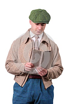 Young man in vintage clothes with hat, reading newspaper, 1940 s