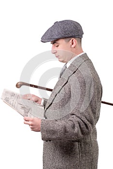 young man in vintage clothes with hat, reading a newspaper, 1940 style