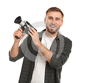 Young man with vintage video camera on background