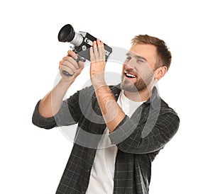 Young man with vintage video camera on background