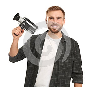 Young man with vintage video camera on white