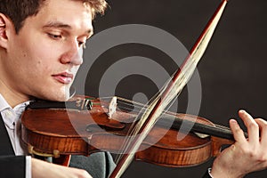 Young man violinist shocked, broken bow