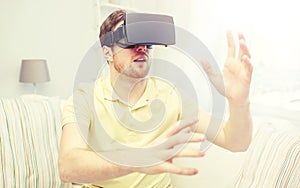 Young man in virtual reality headset or 3d glasses