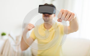 Young man in virtual reality headset or 3d glasses