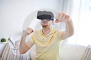 Young man in virtual reality headset or 3d glasses