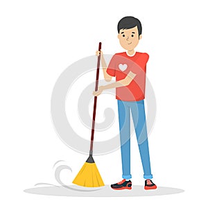 Young man volunteer sweep the floor. Guy holding broom photo