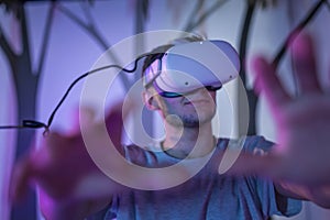 Young man with a VR headset, a simulation of being in the forest