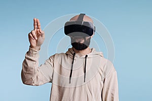 Young man in vr helmet making gesture