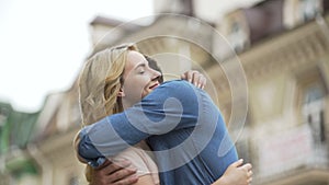 Young man waiting for date, girlfriend coming from behind, apologetic look