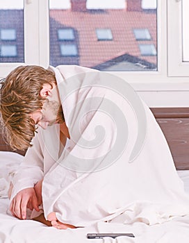 A young man waking up in bed and stretching his arms. Handsome man yawning and stretching his arms up. Morning happy.