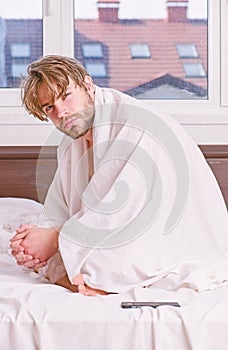 A young man waking up in bed and stretching his arms. Young man stretching while waking up in the morning. Morning hope.