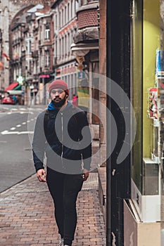 Young Man Walking in Dinant Cityscape