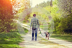Young man walking with dog