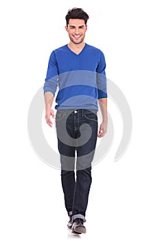 Young man walking forwards towards the camera