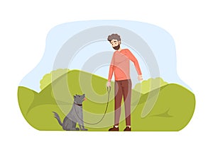 Young man walking with his dog in park