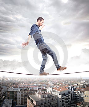 Young man walking on a rope in balance