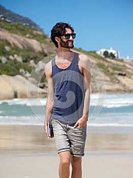 Young man walking on secluded beach