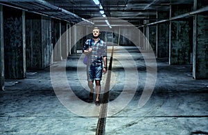 Young man walking through a shadowy basement