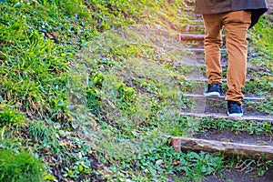 Young man walking up the stairs with natural background.