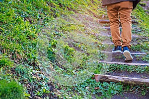 Young man walking up the stairs with natural background.