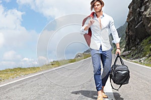 Young man walks down the road