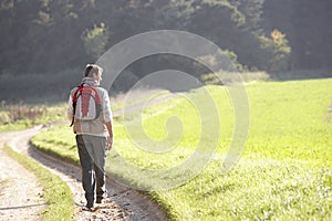 Young man walks in park