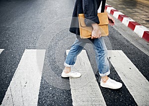 Young man wallking crosswalk commuter lifestyle