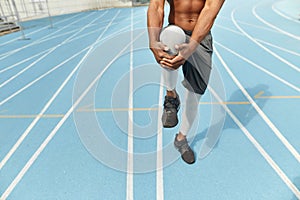 Young man warming up his his legs