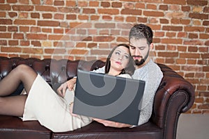 Young man watching up to man on sofa, trust photo
