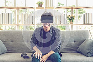 Young man wear VR headset and watch movie in living room