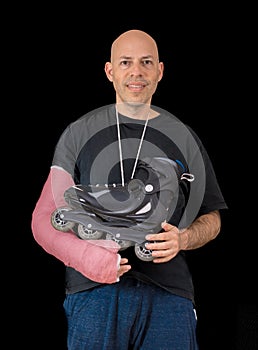 Young man wearing an arm cast after a skating accident