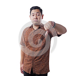 Young Man Wearing Batik Shirt Shows Thumbs Down