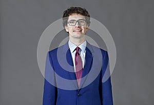 Young man wearing blue suit smiling portrait