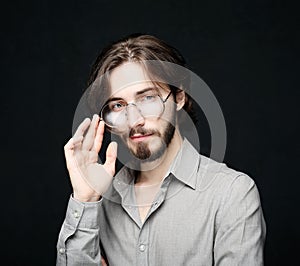 Young man wearing eyeglasses over black background. Lifestyle concept.Close up.