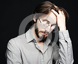 Young man wearing eyeglasses over black background. Lifestyle co