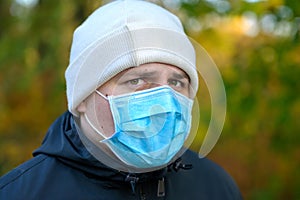 Young man wearing a face mask glancing sideways