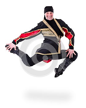 Young man wearing a folk costume jumping against isolated white with copyspace