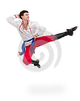 Young man wearing a folk costume jumping against isolated white with copyspace