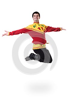 Young man wearing a folk russian costume jumping