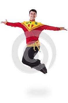 Young man wearing a folk russian costume jumping against isolated white with copyspace